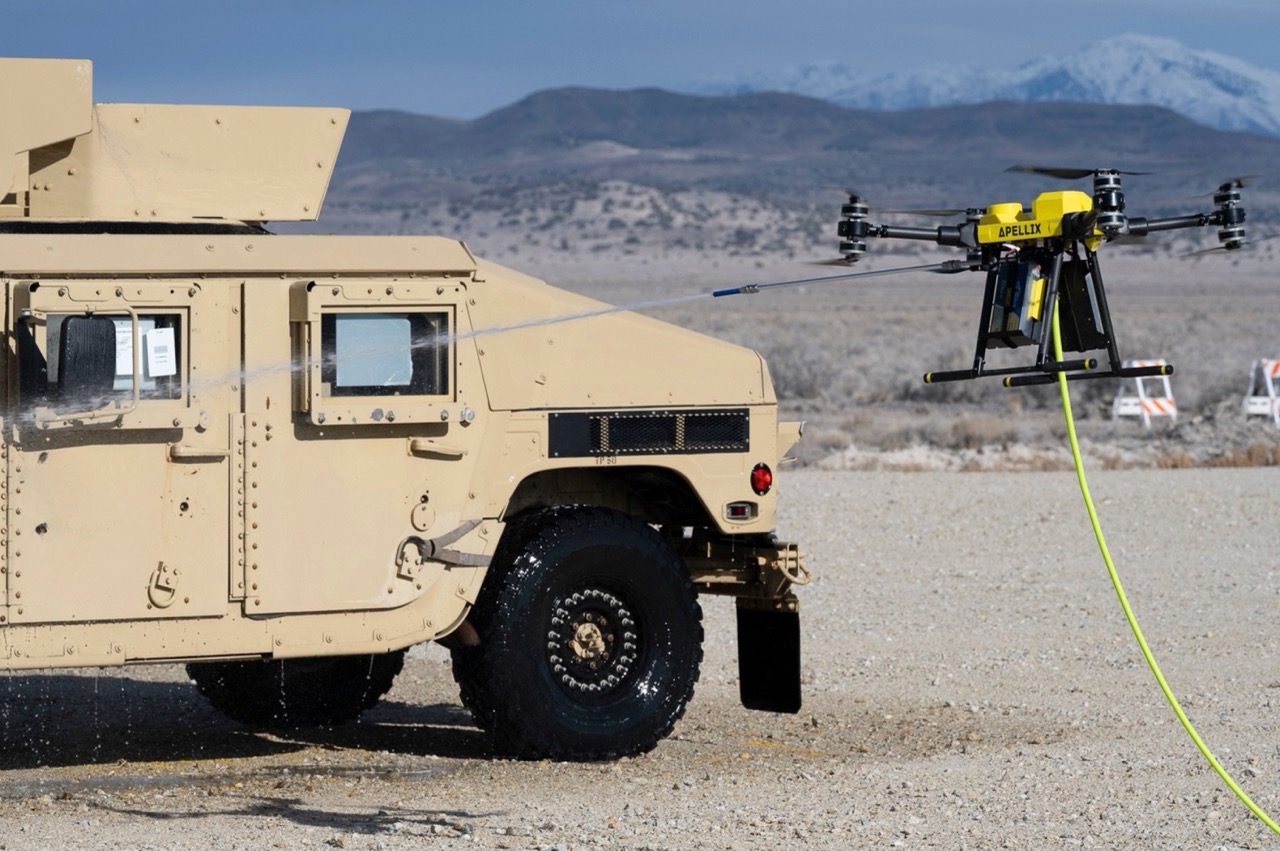 Apellix drone performing CBRN decontamination on military vehicle